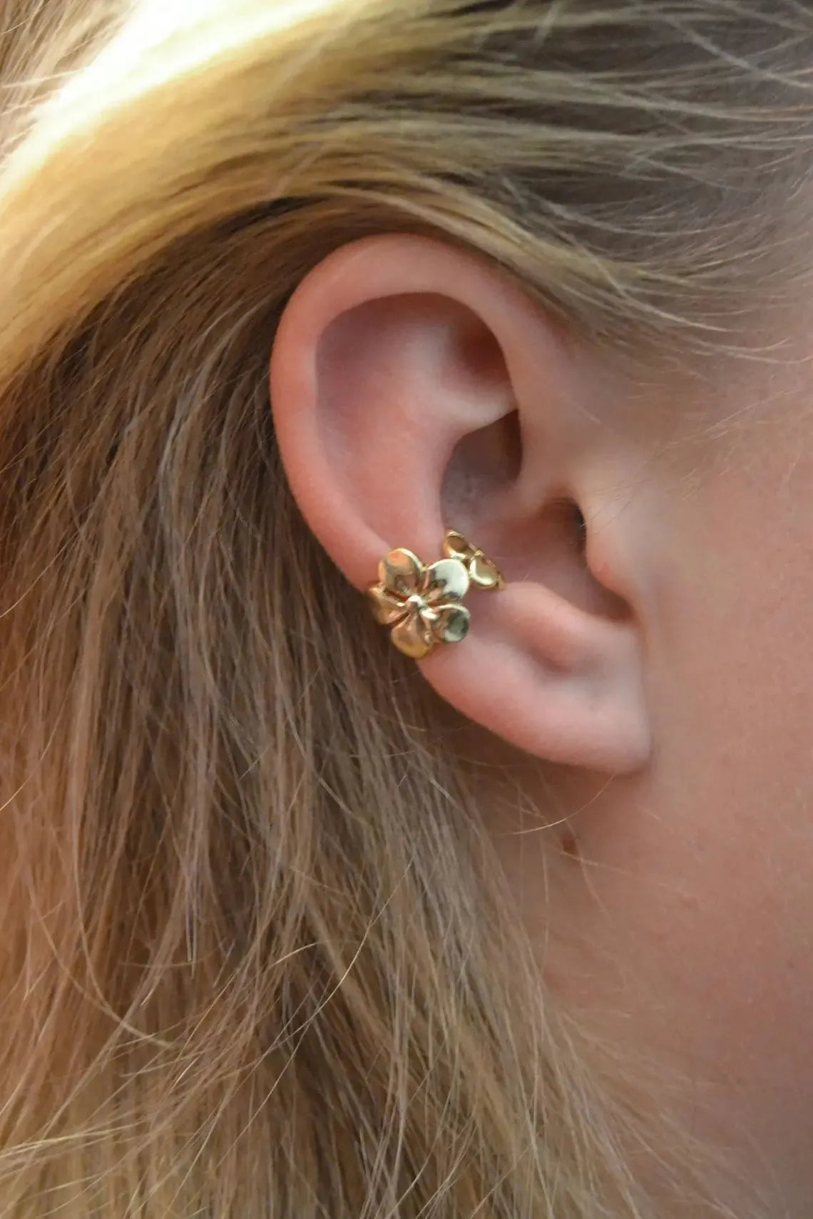 Women's gold alloy earrings with starfish and conch beach elements on post fittings