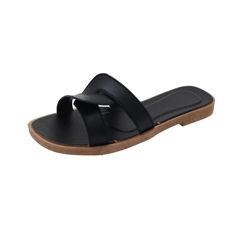 Women's PVC flip flop slippers with a cross strap and toe ring in a solid colour.