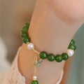 Natural green chalcedony bracelet with round beads and minority design elements for women