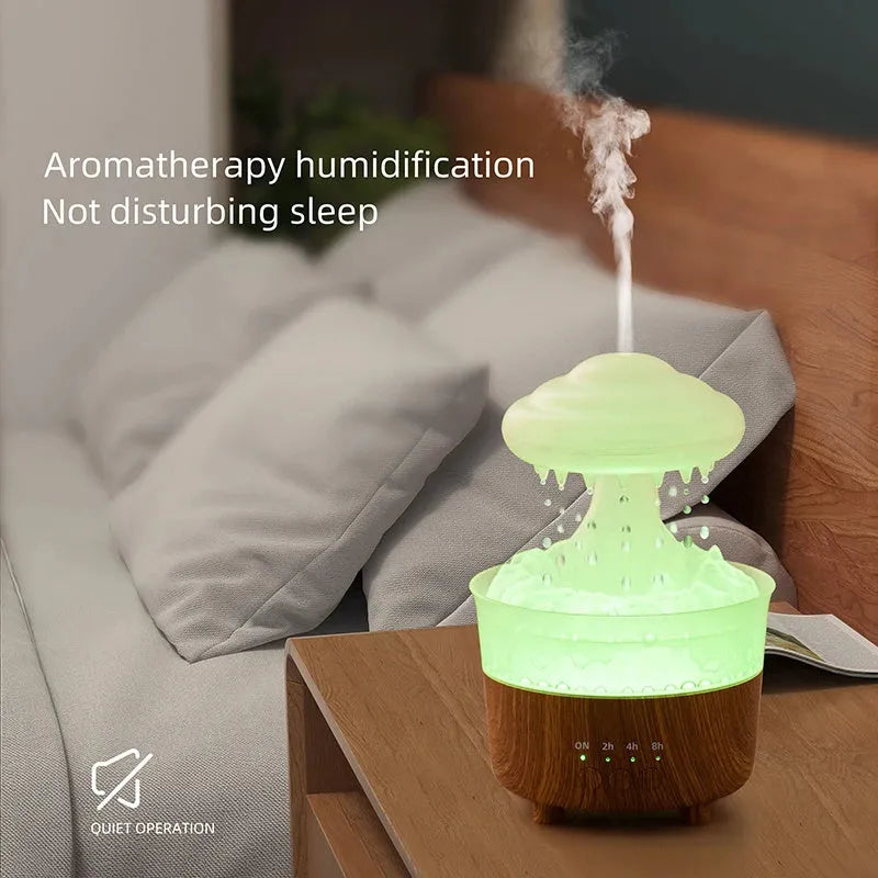 Wood grain white cloud-shaped humidifier and essential oil diffuser with coloured LED night light on a table.