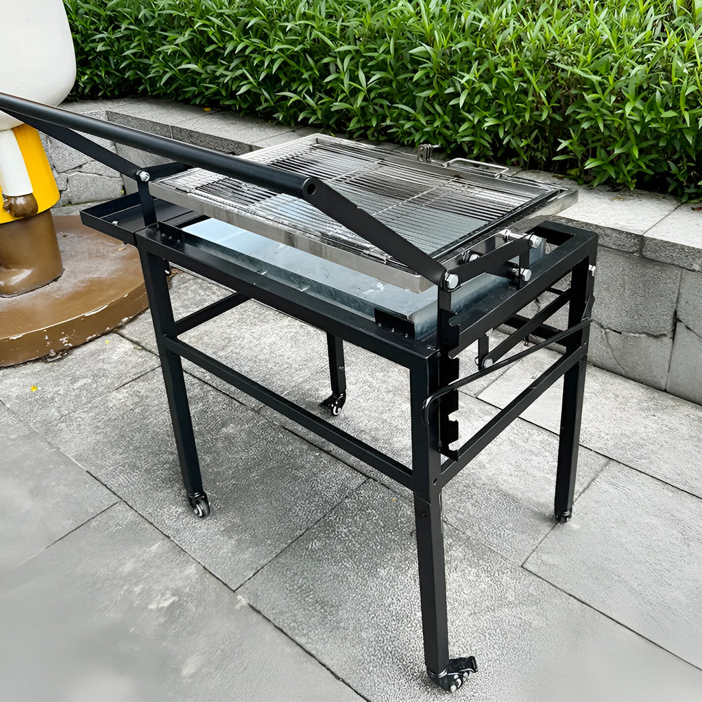 Large foldable charcoal barbecue oven set up in a garden for grilling.