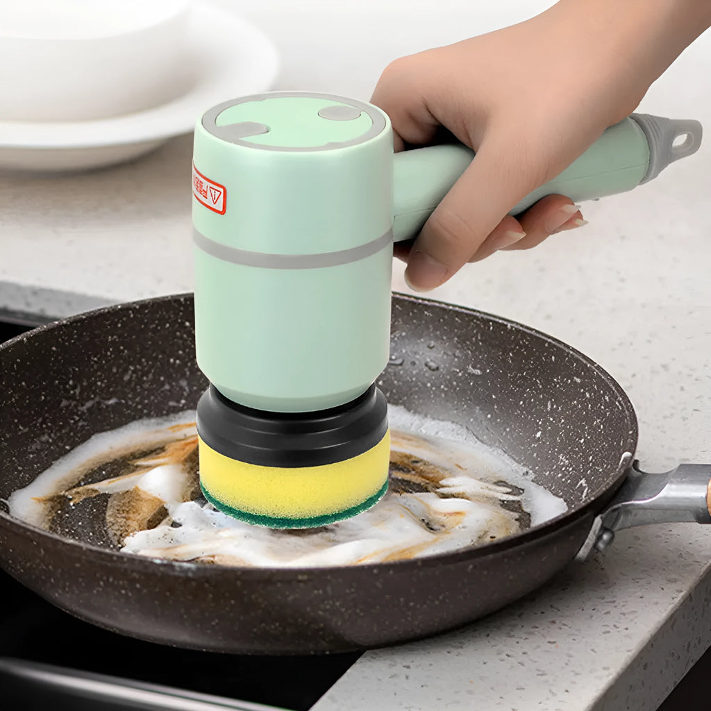 Green rechargeable electric cleaning brush with three interchangeable scrub heads on a kitchen counter.