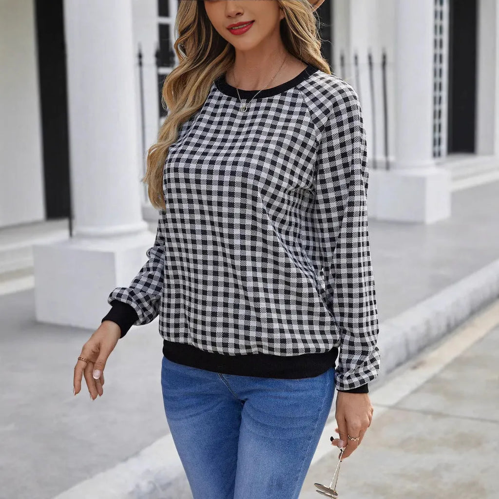 Black long sleeve pullover sweater with a striped plaid pattern, showing regular sleeve cut.
