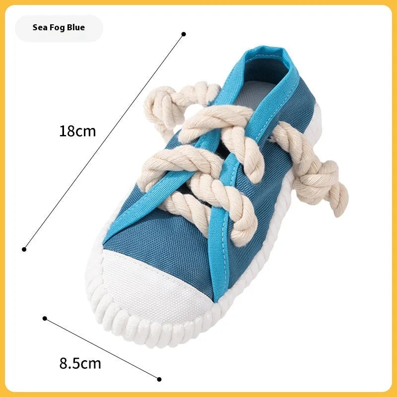 Yellow plastic dog slipper chew toy with a self-hi sound feature for biting.