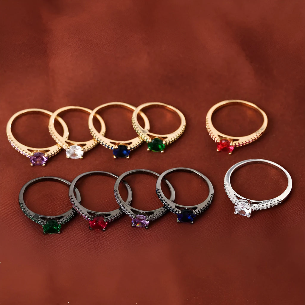 Geometric hexagonal copper ring with colourful zircon stones on a grey background.