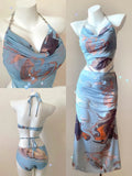 Blue printed women's three-piece bikini set with triangle top, high-waisted briefs, and skirt on hanger.