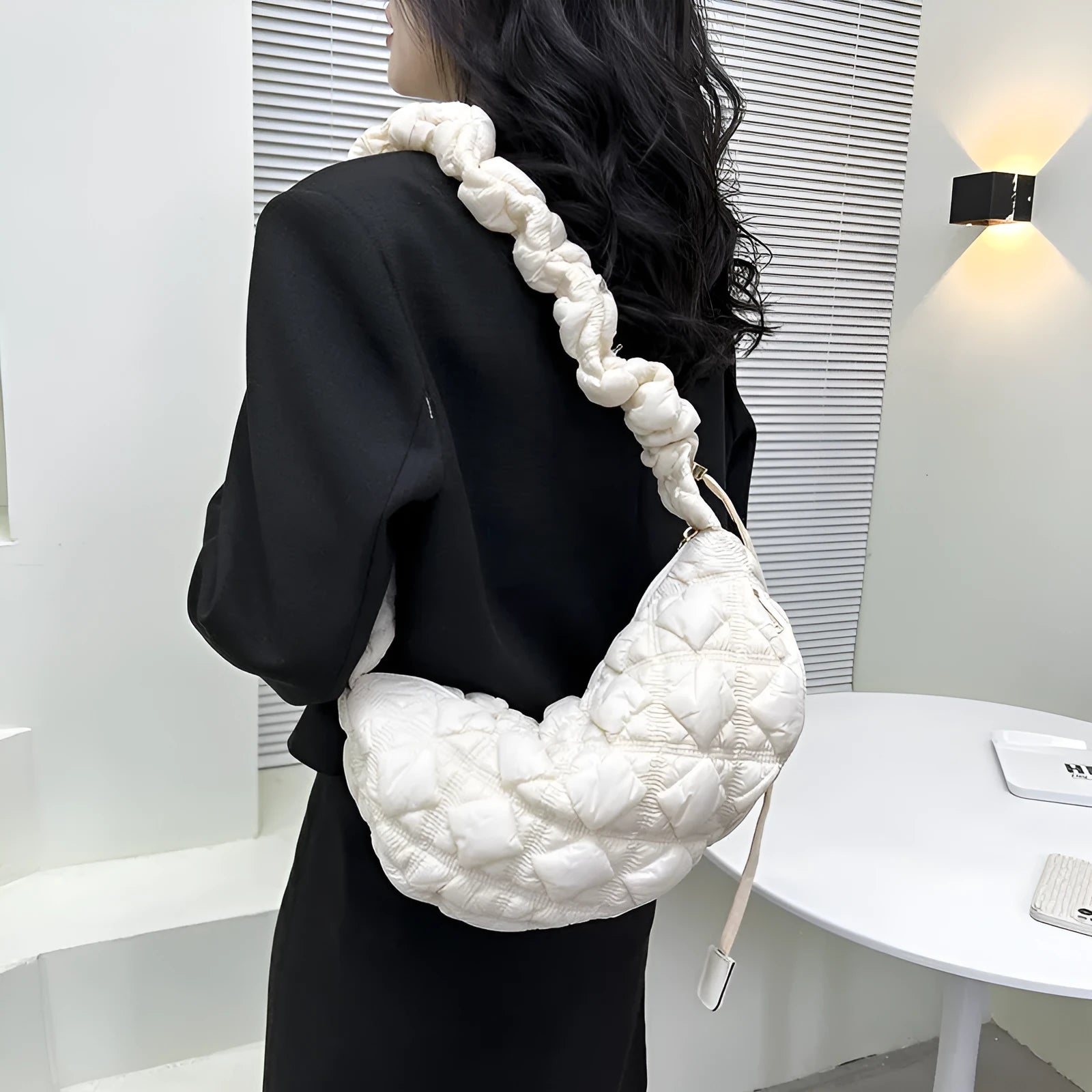 Women's solid colour nylon messenger bag with long shoulder strap shown in beige.