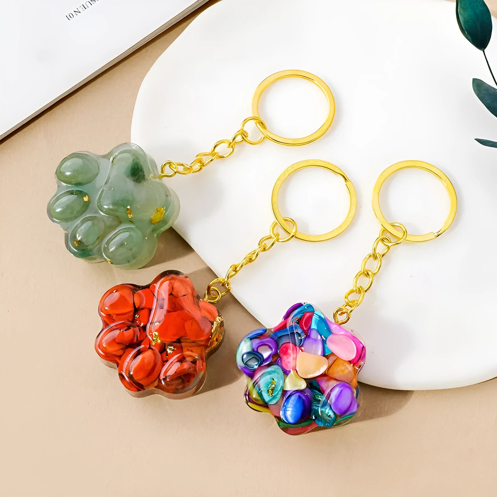 Natural crystal cat's paw keychain pendant on a keyring, colour varies by random gemstone type.