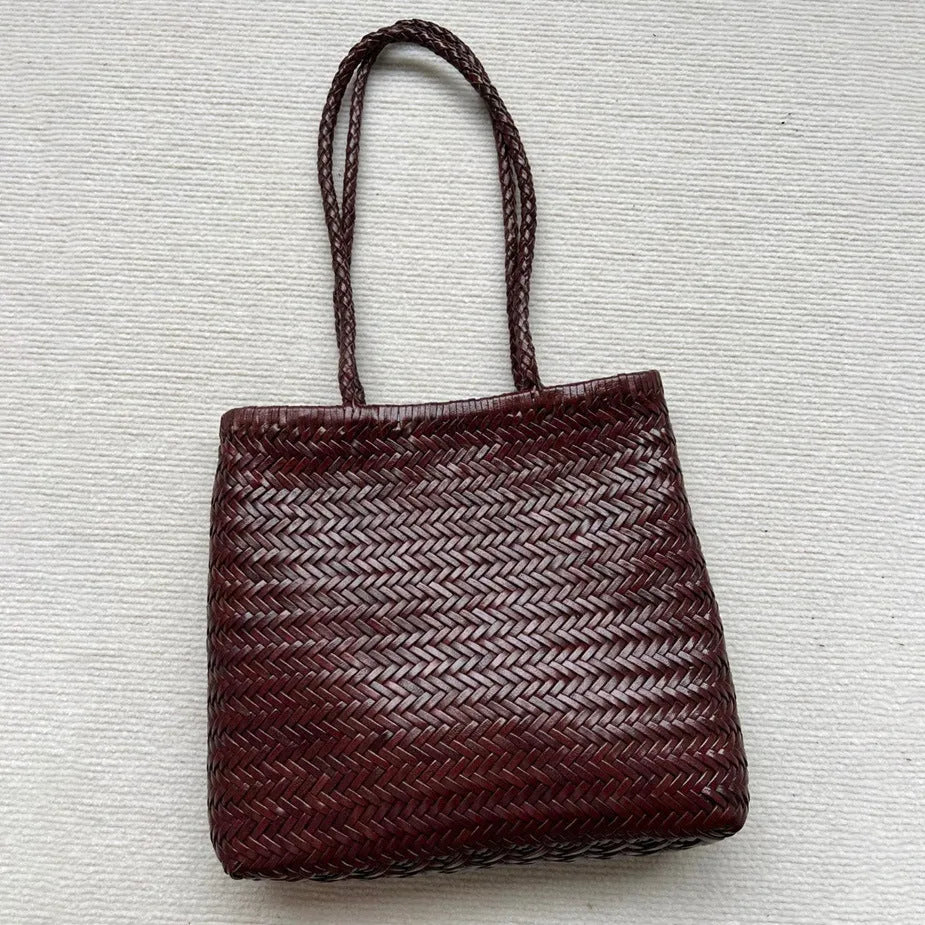 Brown woven leather tote bag with three-dimensional pocket and shoulder strap