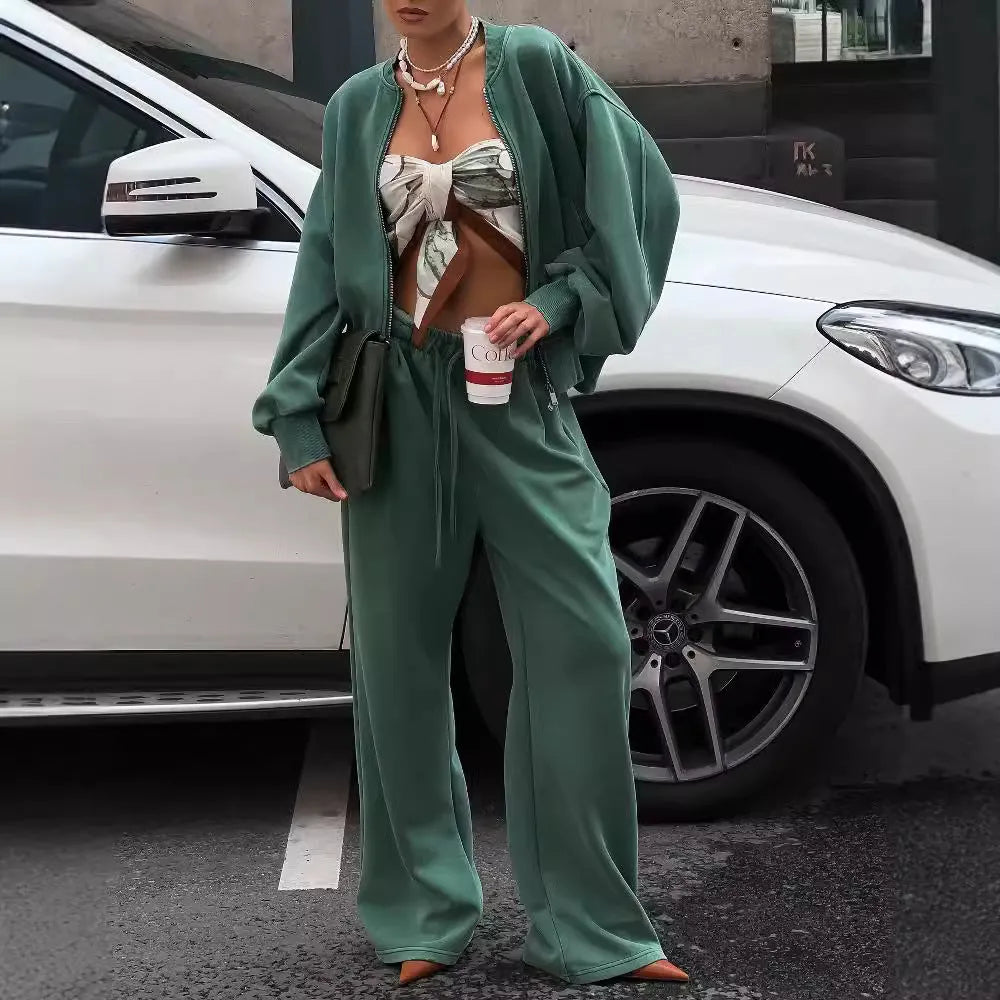 Women's green thermal sweater with front zip and stand collar, paired with matching trousers, on a white background
