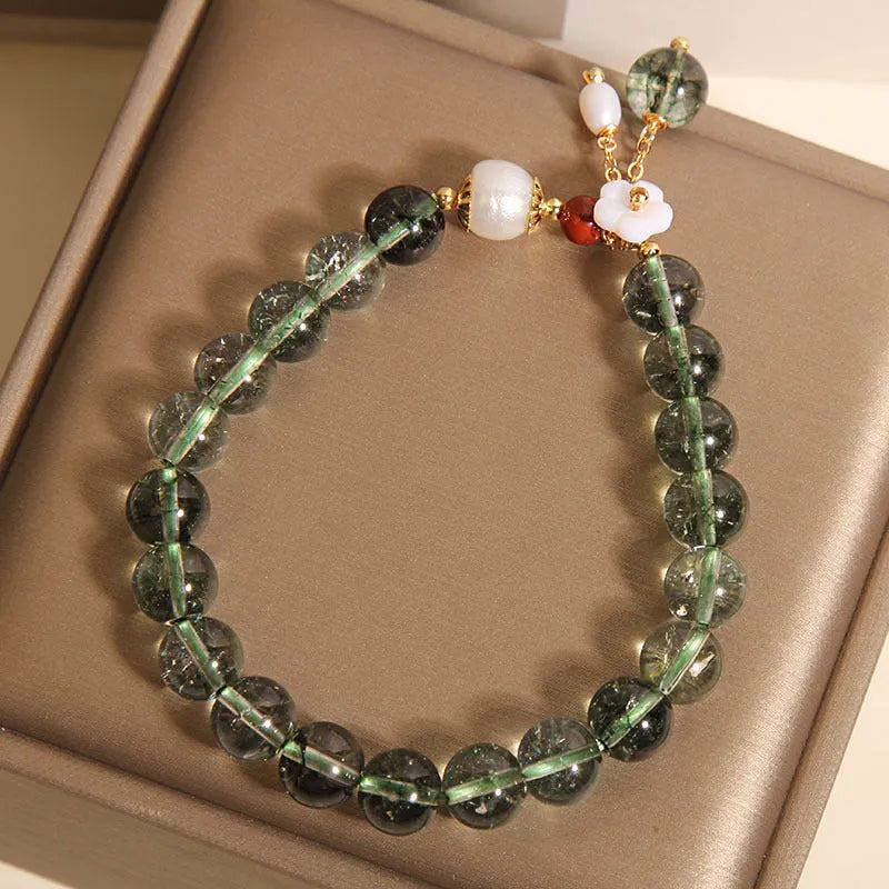 Green phantom quartz crystal bracelet with shell flower and Bells of Ireland design