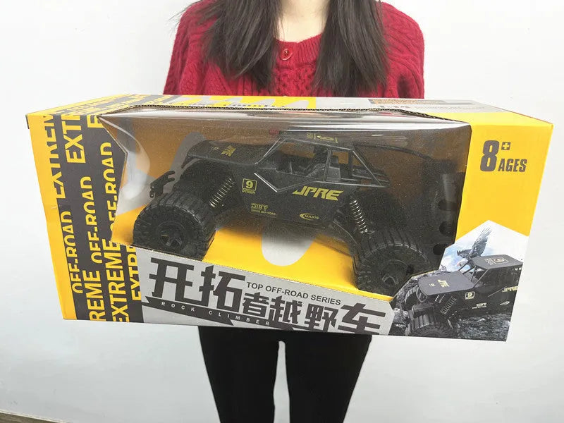 Super large black remote control off-road toy car with four-wheel drive and spring rod design on outdoor ground