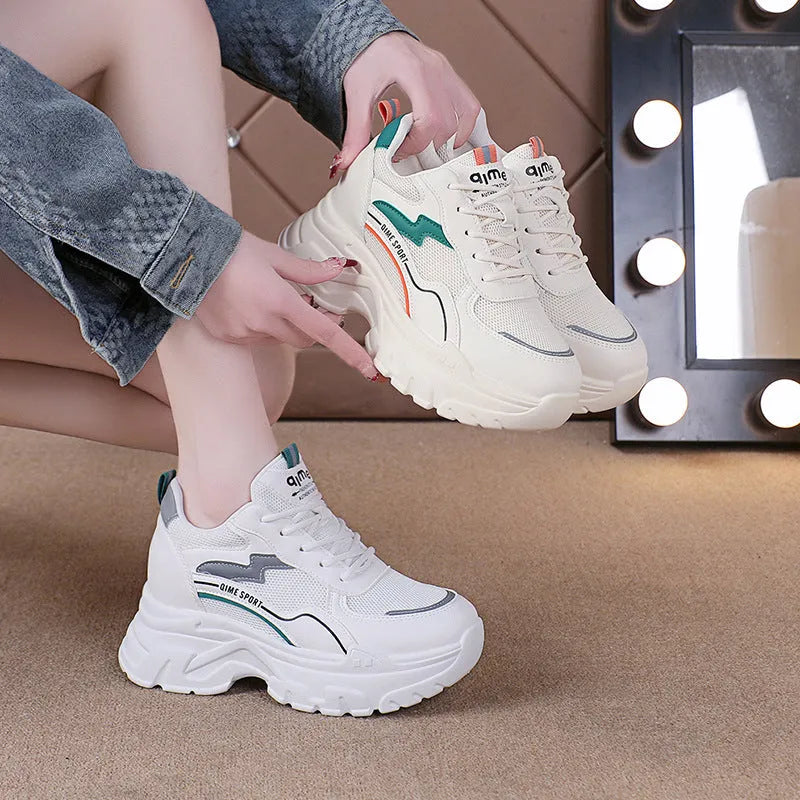 Women's white and beige height-increasing dad shoes with cross straps and lace-up front.