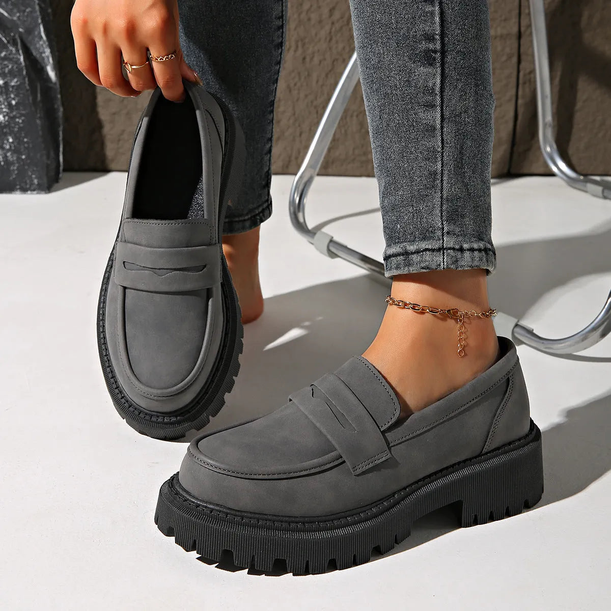 Gray British style slip-on low cut loafers with low heel and rubber sole