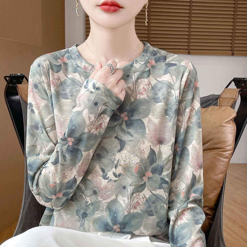 Women's round neck knitted pullover in a Tencel cotton blend with a printed floral design on the front.