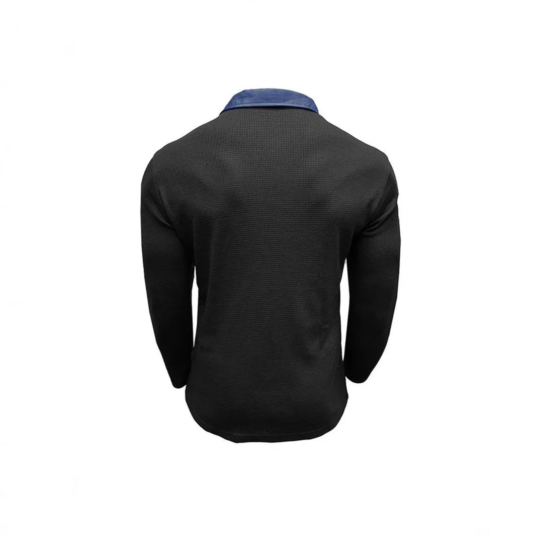 A man wearing a long-sleeved waffle knit polo shirt in a solid colour with a loose, retro fit.