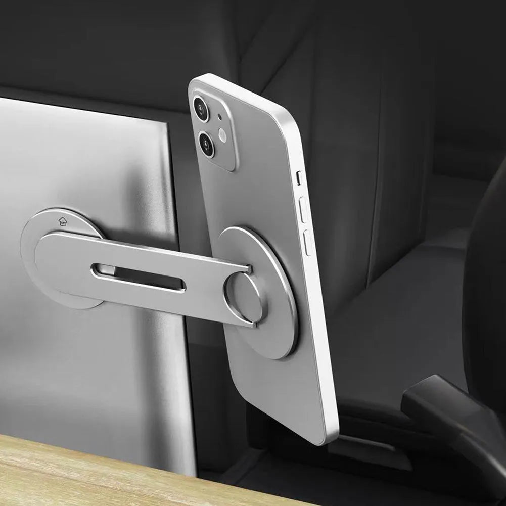 Silver aluminium alloy magnetic car phone holder with 180-degree flip on a car dashboard