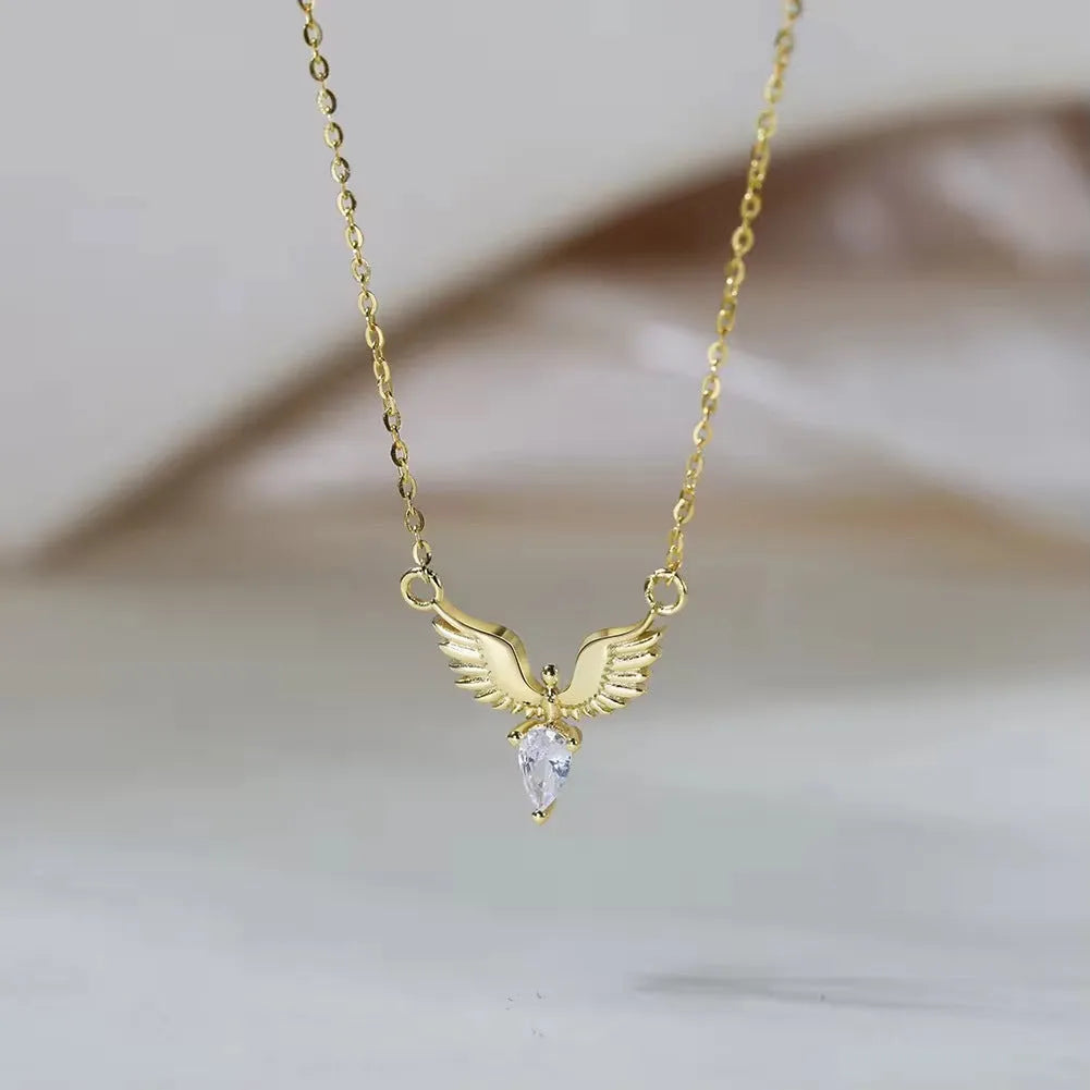 Close-up of a sterling silver eagle pendant necklace on an O-ring chain, showing white gold and yellow gold colour options.