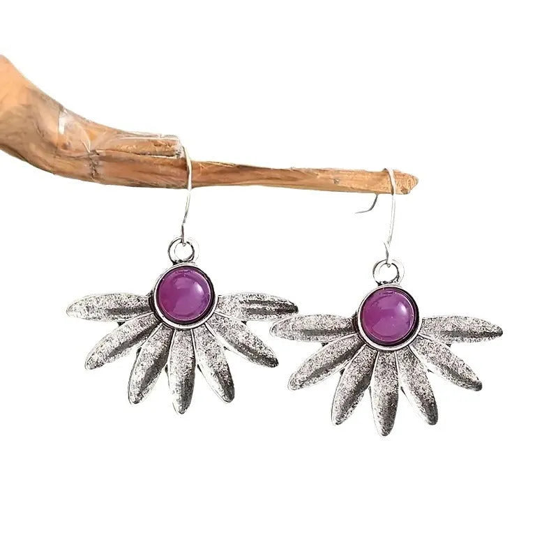 Purple bohemian earrings with zodiac animal design and resin gemstone detailing