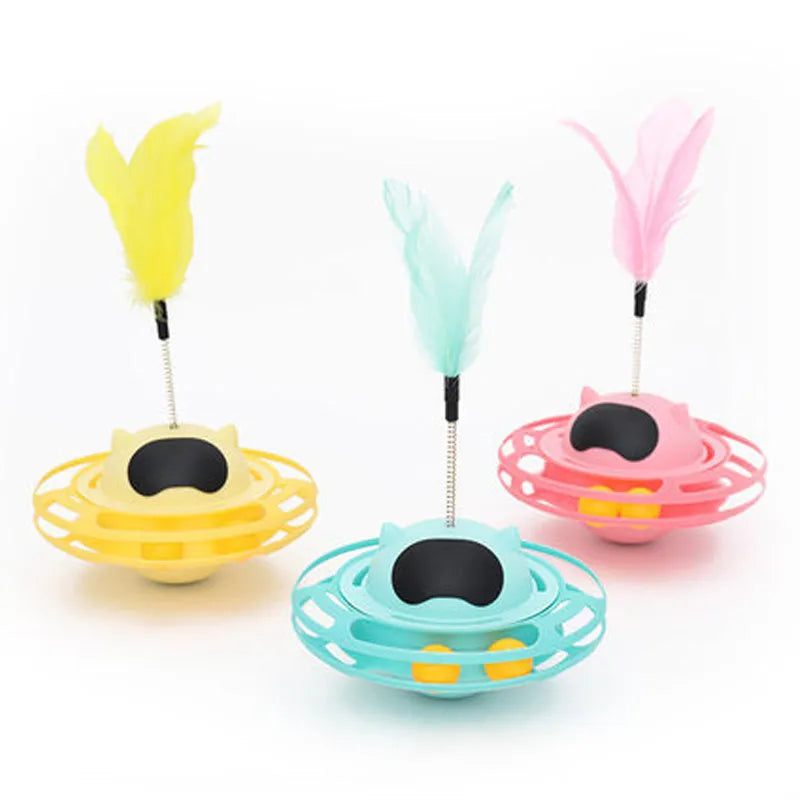 Pink cat tumbler turntable toy with interactive play stick on a flat surface.