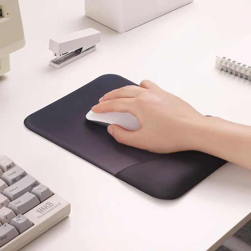 Square silica gel wrist rest mouse pad with cloth top in a choice of colours on a desk.