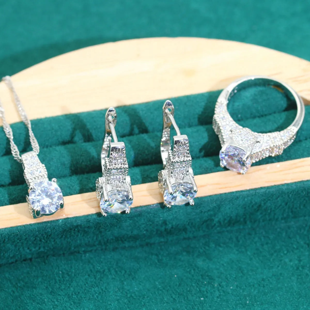 Bridal zircon jewellery set showing necklace, earrings, bracelet, and ring pieces with water wave chain design
