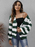 Woman wearing a blue striped cardigan sweater with buttons, showcasing the deer plush fabric texture.
