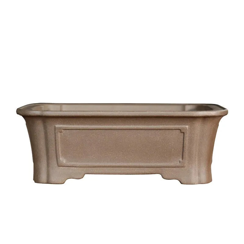 Classical rectangular purple sand bonsai pot with cut corners on a floor.