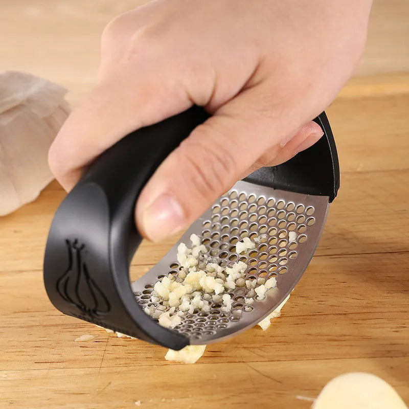 Stainless steel garlic press in black, blue, green, and pink colour options showing 11 x 7 cm dimensions