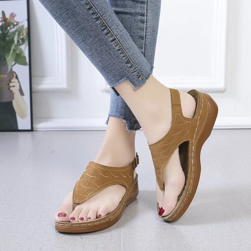 Women's casual wedge heel flip flop sandals with an adjustable buckle strap in a solid colour.