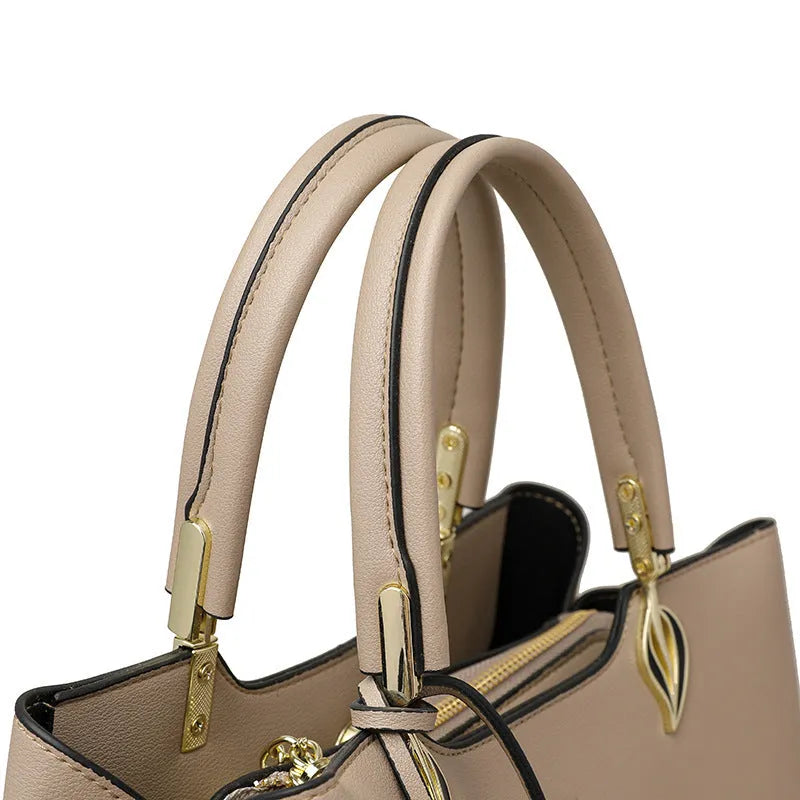 Women's black PU leather shoulder messenger bag with visible stitching and multi-layer interior.