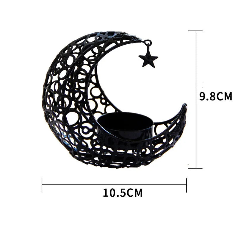 Gold crescent moon metal candle holder with hollow pattern on a wooden table