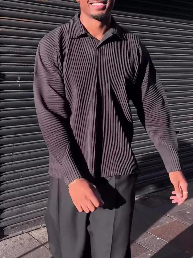 Men's black pleated long-sleeved casual top made from polyester, shown on a model.