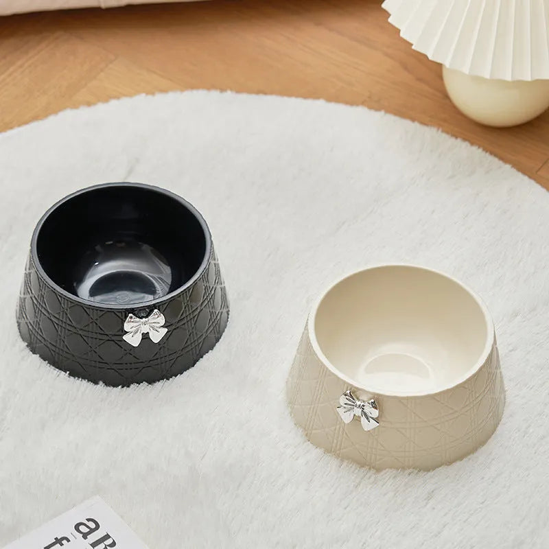 Set of four pet food bowls with bowknot design and diamond pattern in pink, silver, black, purple, and white colours.