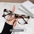 Women's large cat's eye frame glasses with dragon and phoenix decorations, shown in various colour options.