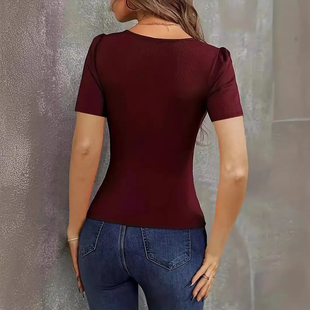 Women's wine red knitted short sleeve top with low neckline and slim fit on mannequin