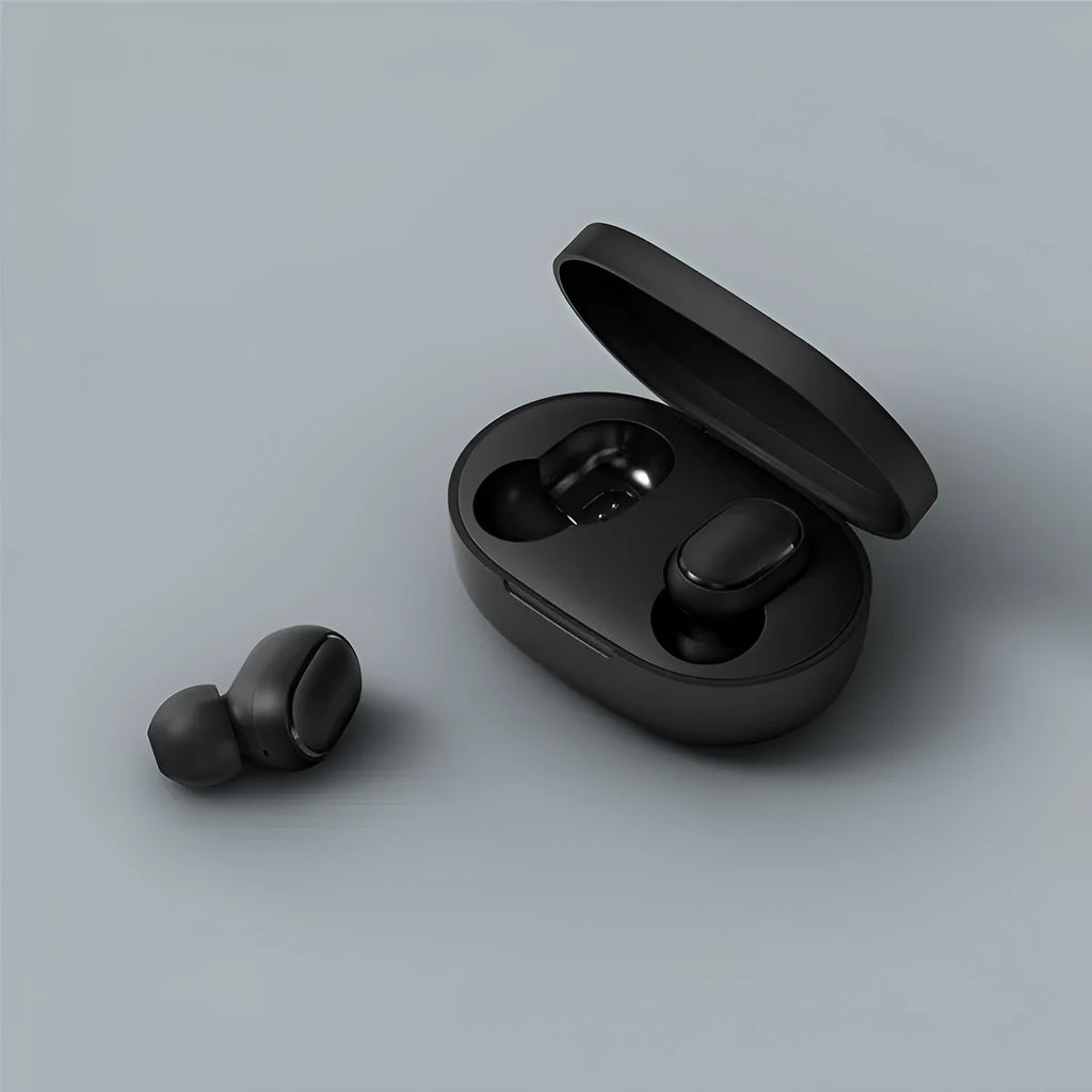 Redmi AirDots black true wireless earbuds and charging case on a table.