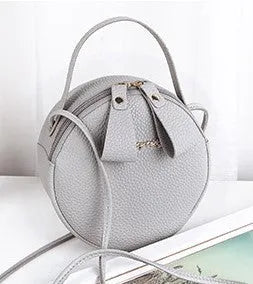 Women's round PU leather crossbody bag in circular shape, 17cm wide, with separate pouch