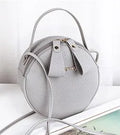 Women's round PU leather crossbody bag in circular shape, 17cm wide, with separate pouch