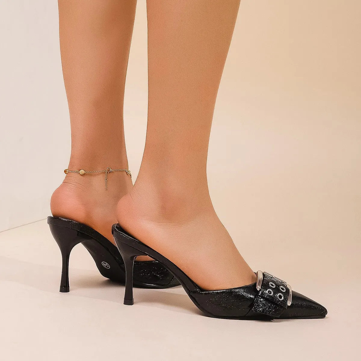 Black women's high heel shoes with pointed toe, ankle strap, and buckle decoration