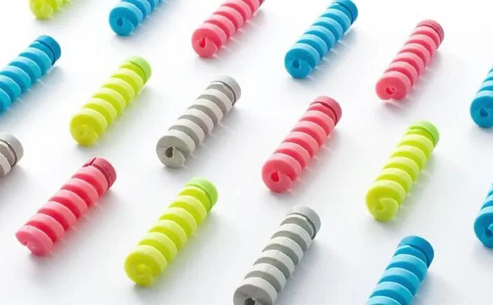 Plastic charging cable protector in various colours, shown next to a USB cable.