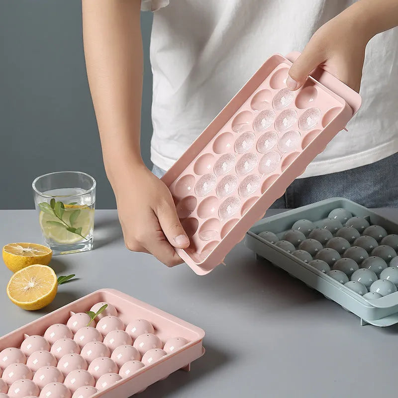 Sky blue round ball ice cube mould with 18 spherical cavities on a kitchen counter