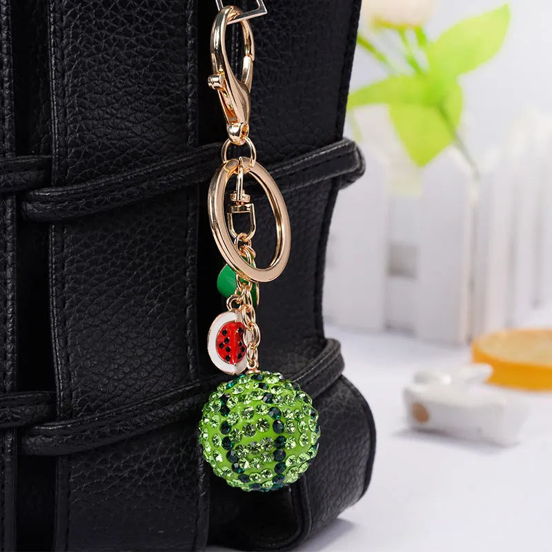 Green zinc alloy watermelon keychain with diamond pattern measuring 12 cm