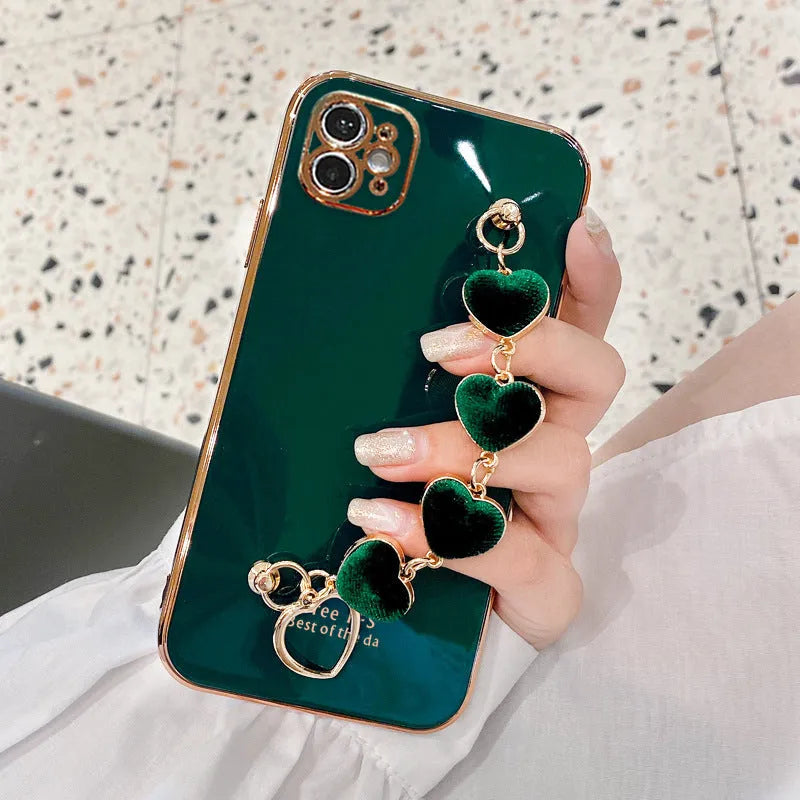 Samsung mobile phone in a solid colour silicone case with an adjustable bracelet strap attached.