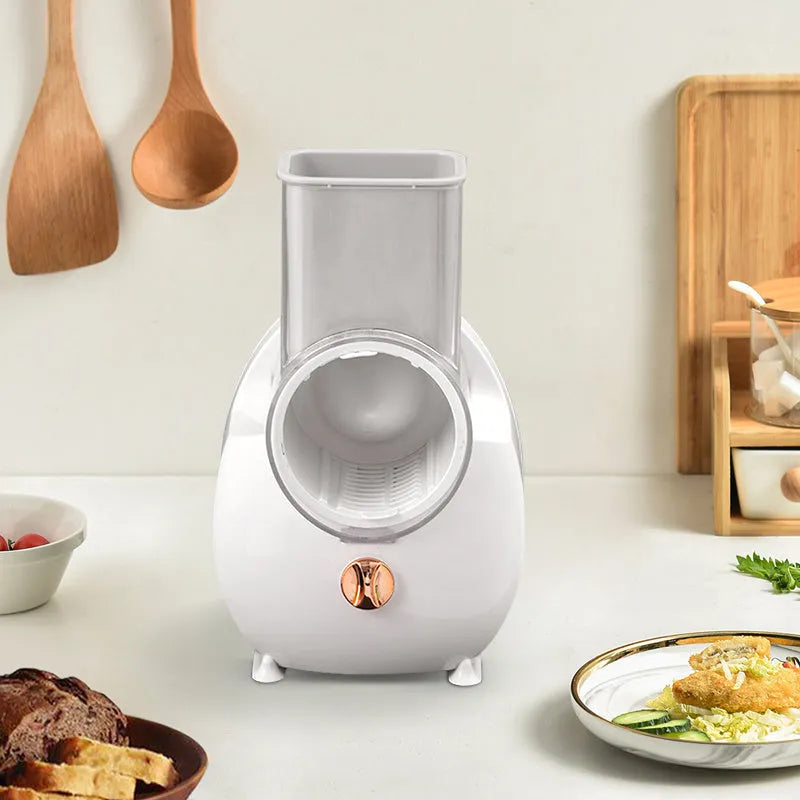 White electric vegetable slicer with rotary cutting mechanism and suction base for kitchen use