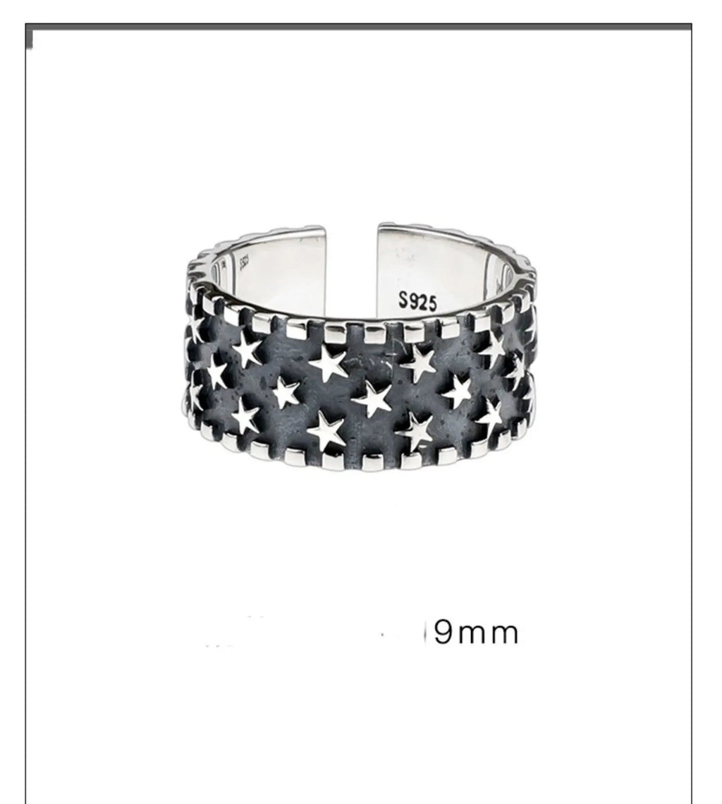 Sterling silver adjustable ring with a geometric pattern of multiple five-pointed stars.
