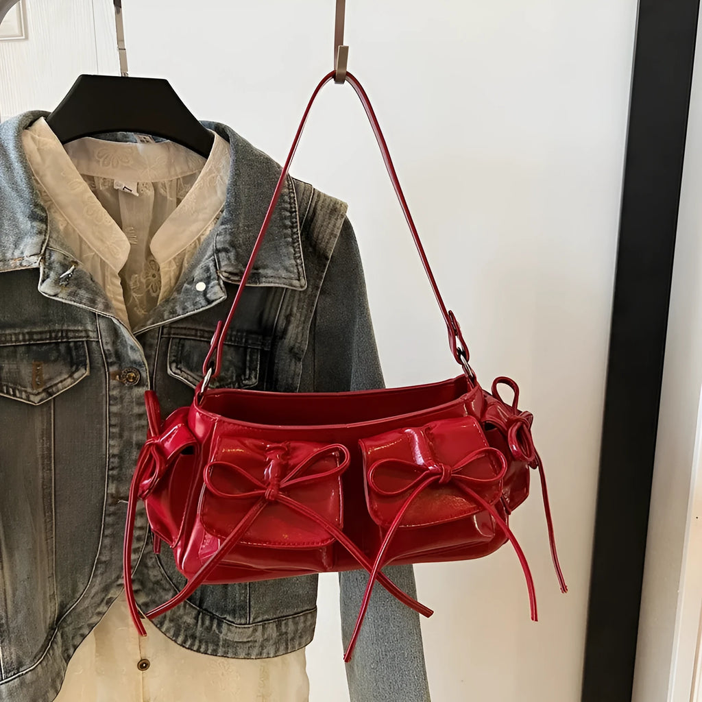 Women's pleated shoulder bag with a tassel bow, showing multi-pocket design and available in eight colours.