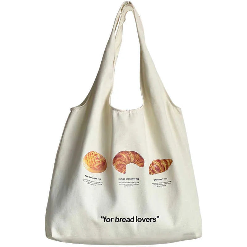Beige canvas shoulder bag with bread design showing 44cm width and adjustable shoulder strap