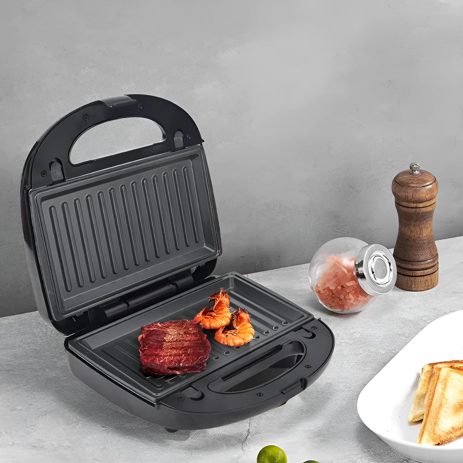Black electric sandwich pan with double-sided heating, non-stick coating, and six exchangeable pans