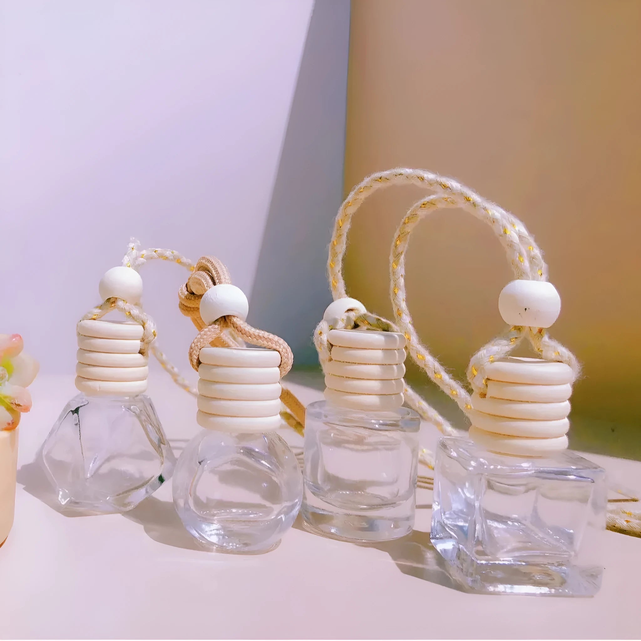 Glass car perfume pendant air freshener in cylinder, diamond, flat drum, and square shapes.